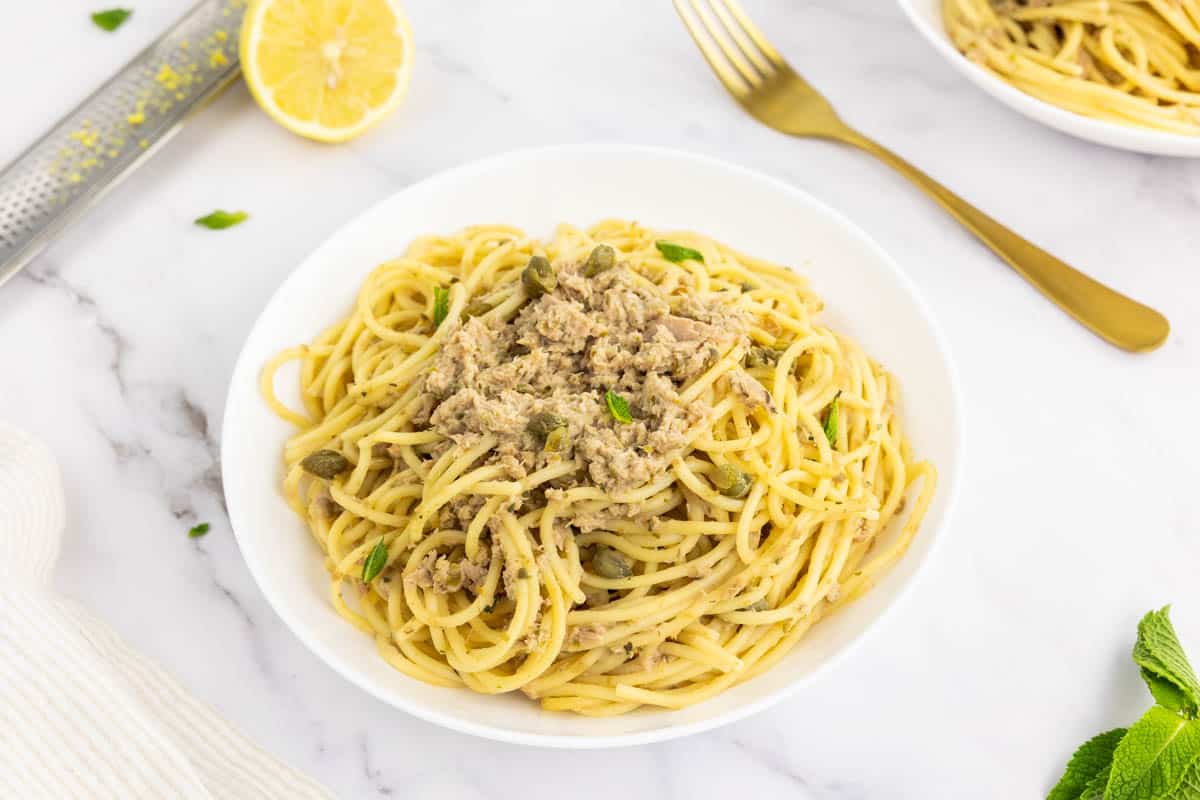 Canned tuna seafood pasta in white bowl.